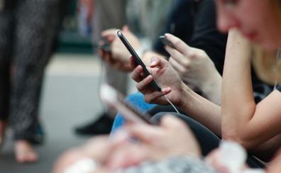 A close up of someone holding a cell phone in one hand